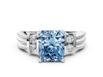 Three-Stone Fancy Blue Radiant Cut Diamond Channel Set Ring in White gold with Bar Prongs