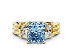 Three-Stone Fancy Blue Radiant Cut Diamond Channel Set Ring in Yellow gold with Bar Prongs