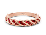 Twisted Pavé Round Ruby Eternity Band in Rose gold with Shared Prong Setting
