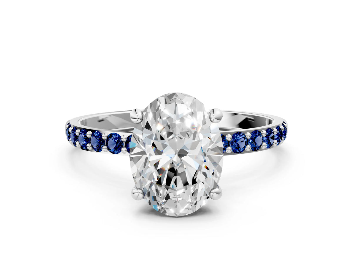 White gold Oval Cut Diamond Solitaire Ring with Round Blue Sapphire Pavé Band and Prong Setting