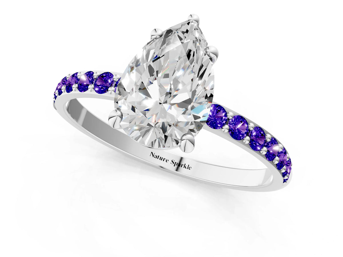 White gold Pear Cut Diamond Solitaire Ring with Round Tanzanite Pavé Band and Prong Setting_1
