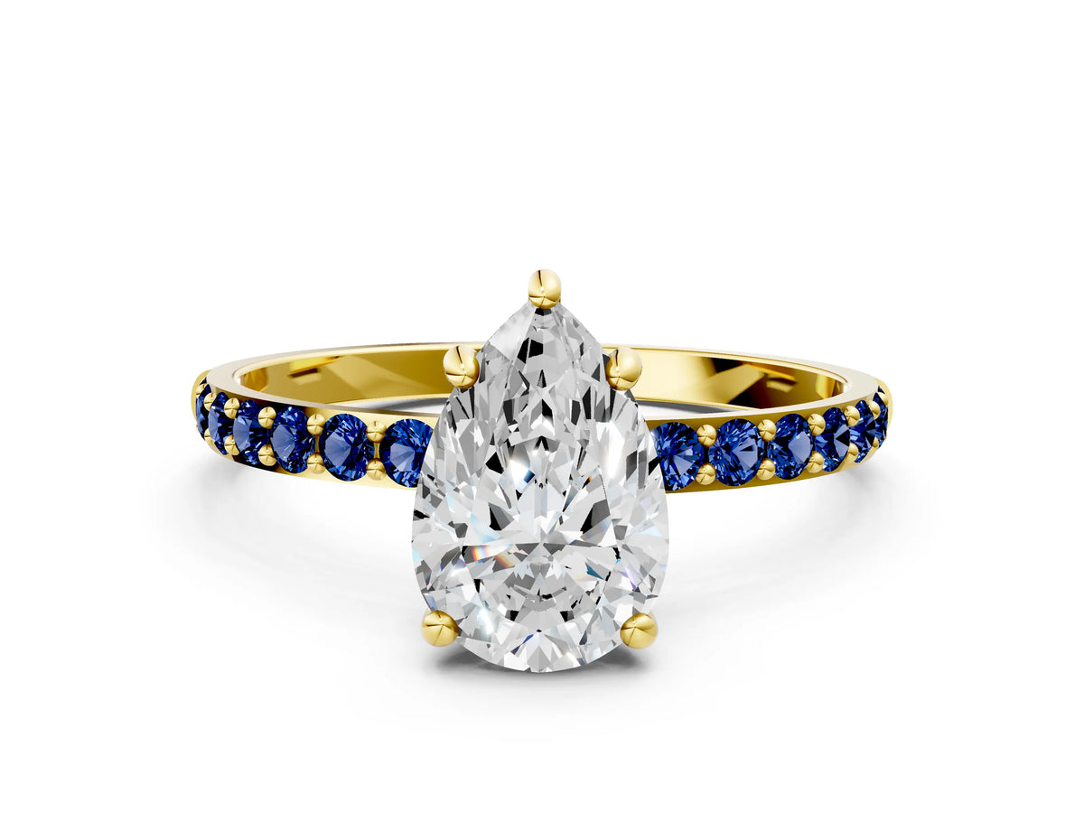 Yellow gold Pear Cut Diamond Solitaire Ring with Round Blue Sapphire Pavé Band and Prong Setting