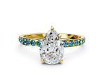 Yellow gold Pear Cut Diamond Solitaire Ring with Round Blue Topaz Pavé Band and Prong Setting