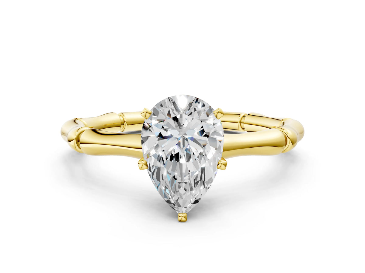 Yellow gold Pear Cut Solitaire Diamond Ring with Bamboo Band and Four-Prong Setting