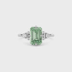 White gold Fancy Green Emerald Cut Three Stone Diamond Engagement Ring with Tapered Baguette and Round Side Stones