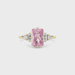 Yellow gold Fancy Pink Radiant Cut Three Stone Diamond Engagement Ring with Tapered Baguette and Round Side Stones