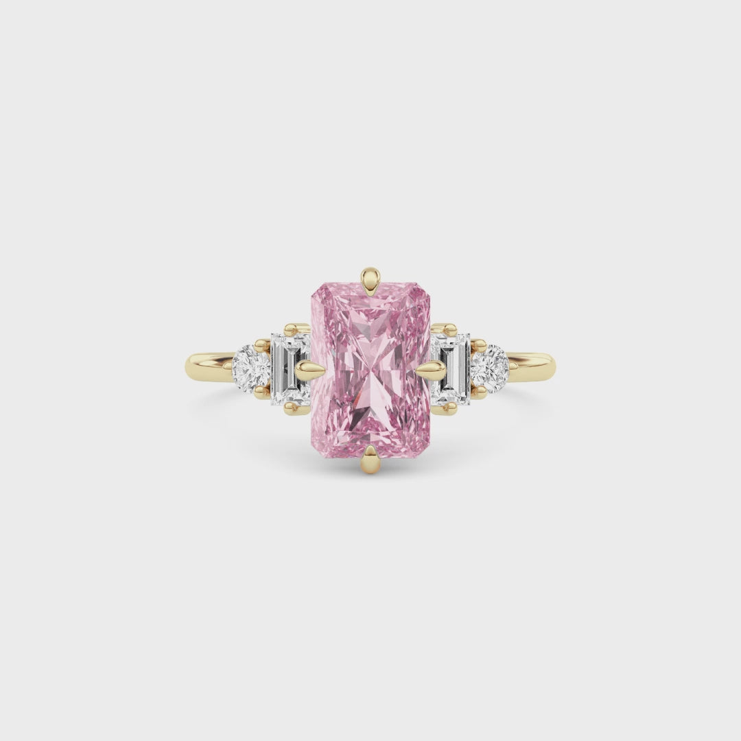 Yellow gold Fancy Pink Radiant Cut Three Stone Diamond Engagement Ring with Tapered Baguette and Round Side Stones