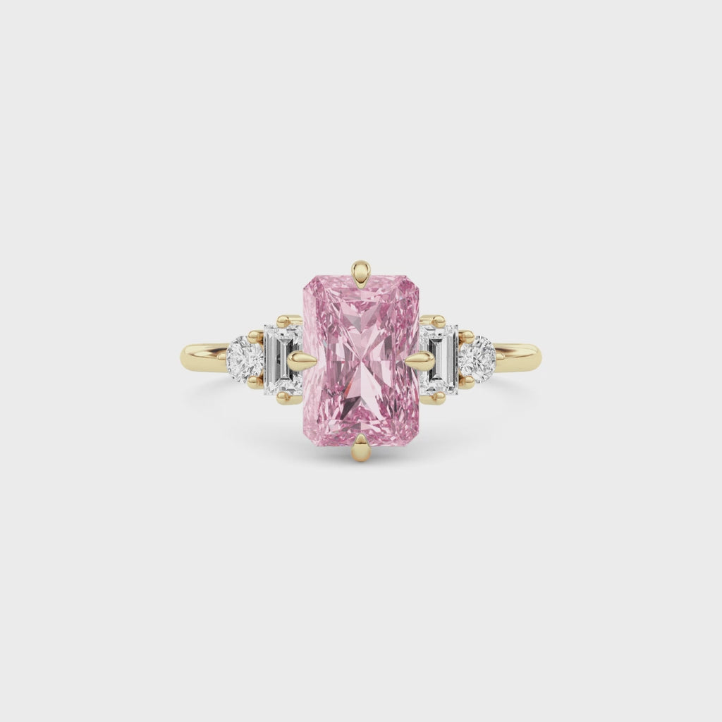 Yellow gold Fancy Pink Radiant Cut Three Stone Diamond Engagement Ring with Tapered Baguette and Round Side Stones