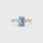 Yellow gold Three-Stone Fancy Blue Emerald Cut Diamond Ring with Tapered Baguette Side Stones