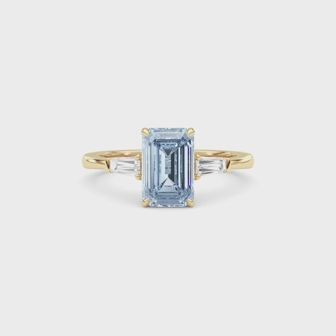 Yellow gold Three-Stone Fancy Blue Emerald Cut Diamond Ring with Tapered Baguette Side Stones