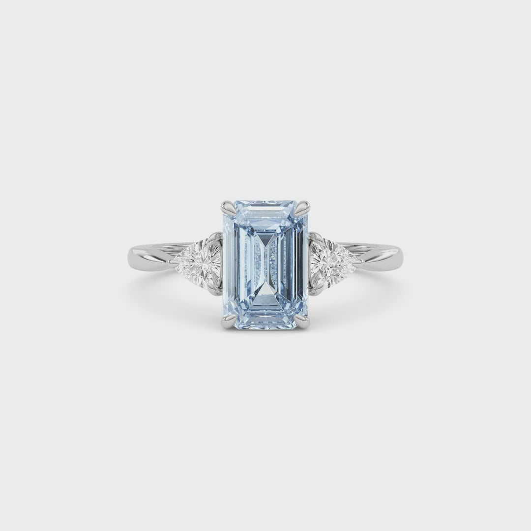 White gold Three-Stone Fancy Blue Emerald Cut Diamond Ring with Trillion Side Stones