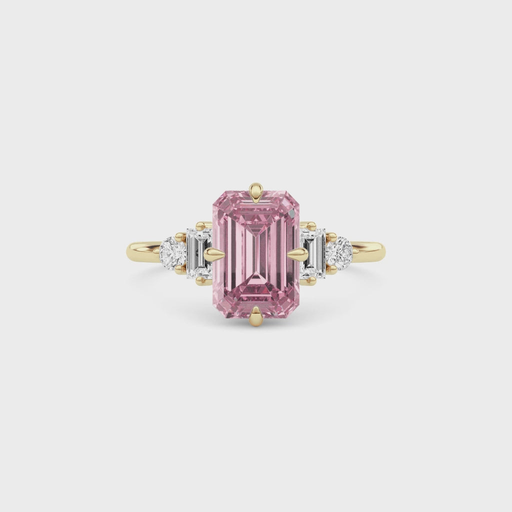Yellow gold Fancy Pink Emerald Cut Three Stone Diamond Engagement Ring with Tapered Baguette and Round Side Stones
