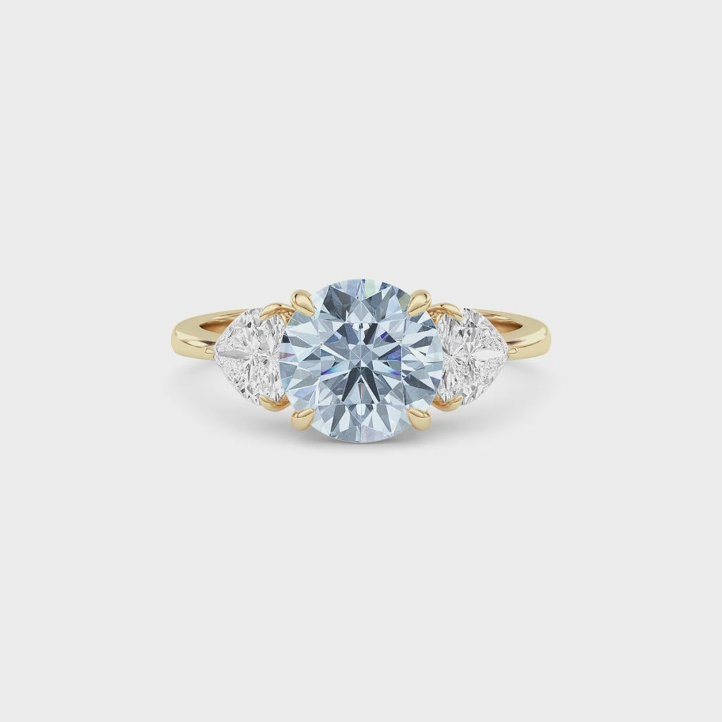 Yellow gold Three-Stone Fancy Blue Round Cut Diamond Ring with Heart Side Stones