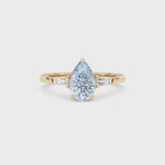 Yellow gold Three-Stone Fancy Blue Pear Cut Diamond Ring with Tapered Baguette Side Stones