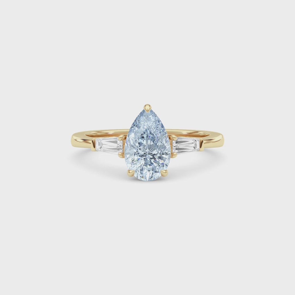 Yellow gold Three-Stone Fancy Blue Pear Cut Diamond Ring with Tapered Baguette Side Stones