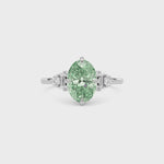 White gold Fancy Green Oval Cut Three Stone Diamond Engagement Ring with Tapered Baguette and Round Side Stones