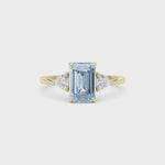 Yellow gold Three-Stone Fancy Blue Emerald Cut Diamond Ring with Trillion Side Stones