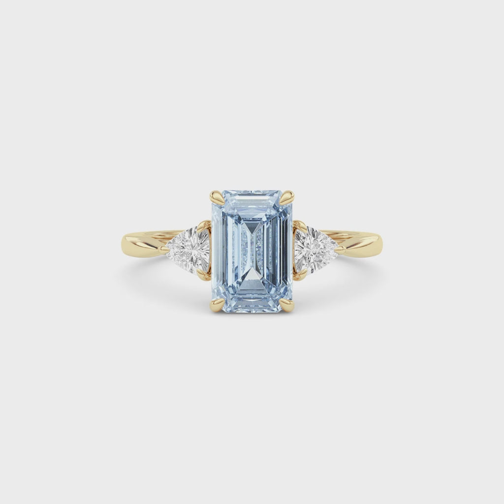 Yellow gold Three-Stone Fancy Blue Emerald Cut Diamond Ring with Trillion Side Stones