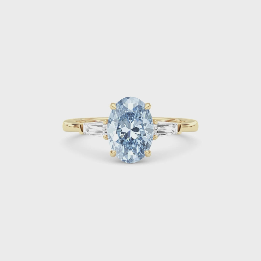 Yellow gold Three-Stone Fancy Blue Oval Cut Diamond Ring with Tapered Baguette Side Stones
