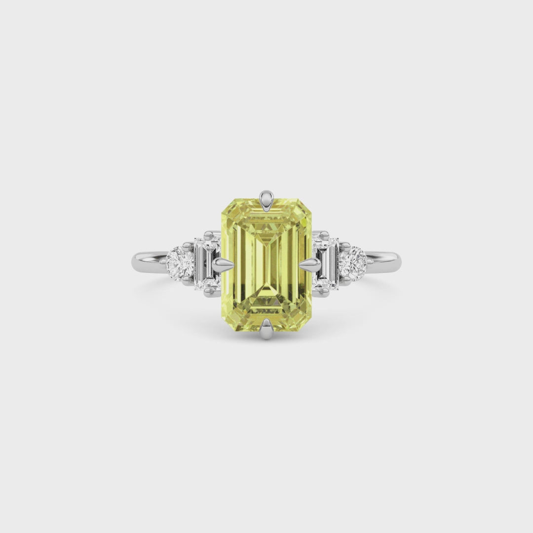 Yellow gold Fancy Yellow Emerald Cut Three Stone Diamond Engagement Ring with Tapered Baguette and Round Side Stones