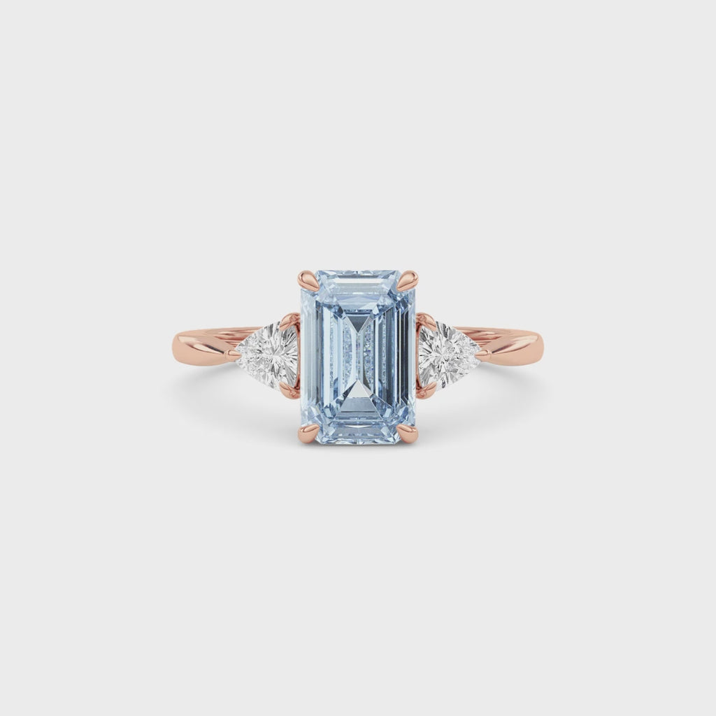 Rose gold Three-Stone Fancy Blue Emerald Cut Diamond Ring with Trillion Side Stones