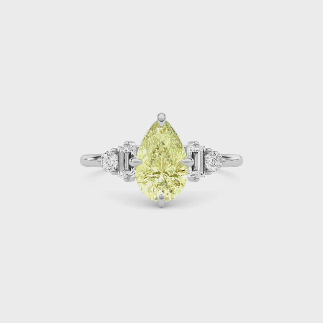 Yellow gold Fancy Yellow Pear Cut Three Stone Diamond Engagement Ring with Tapered Baguette and Round Side Stones
