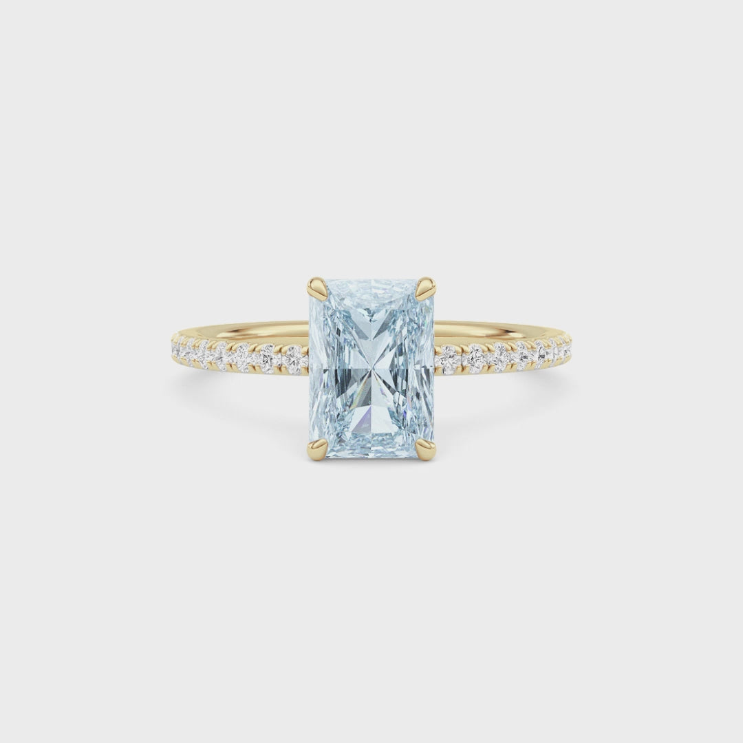 Yellow gold Fancy Blue Radiant Cut Diamond Solitaire with Pavé Band