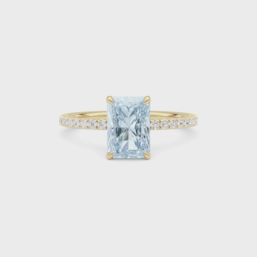 Yellow gold Fancy Blue Radiant Cut Diamond Solitaire with Pavé Band
