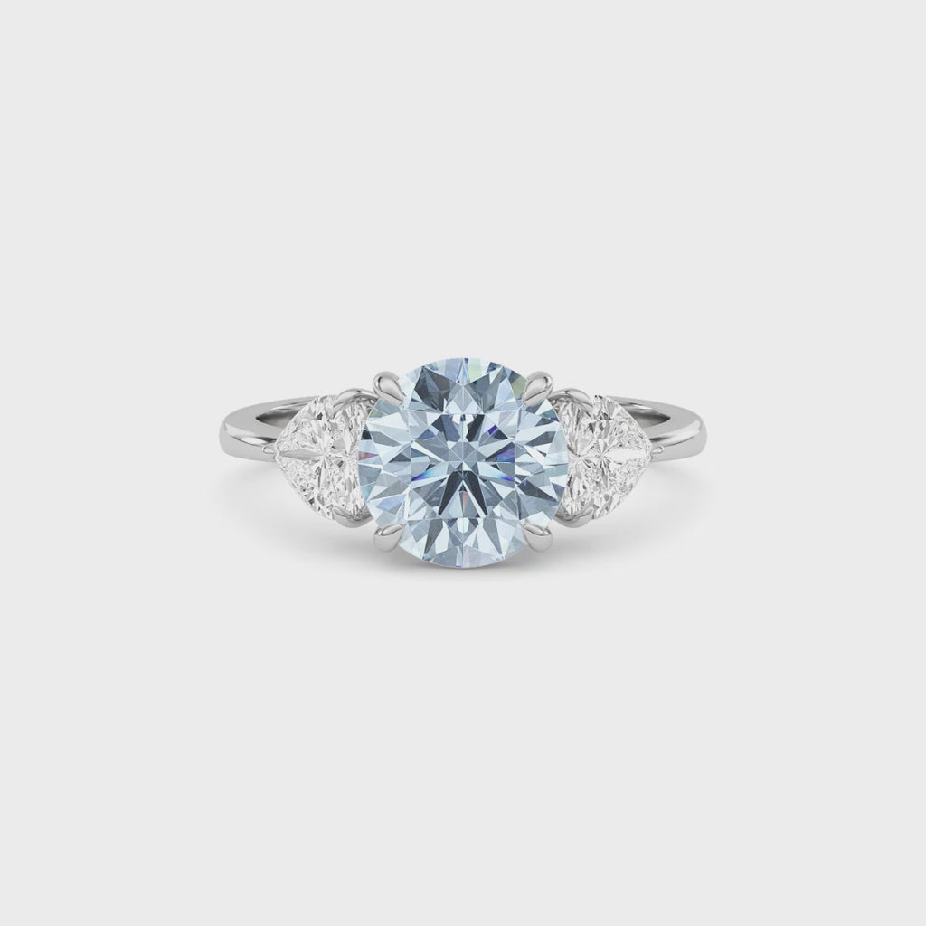 White gold Three-Stone Fancy Blue Round Cut Diamond Ring with Heart Side Stones
