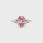 Yellow gold Fancy Pink Oval Cut Three Stone Diamond Engagement Ring with Tapered Baguette and Round Side Stones