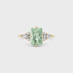 Yellow gold Fancy Green Radiant Cut Three Stone Diamond Engagement Ring with Tapered Baguette and Round Side Stones