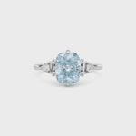 White gold Fancy Blue Cushion Cut Three Stone Diamond Engagement Ring with Tapered Baguette and Round Side Stones