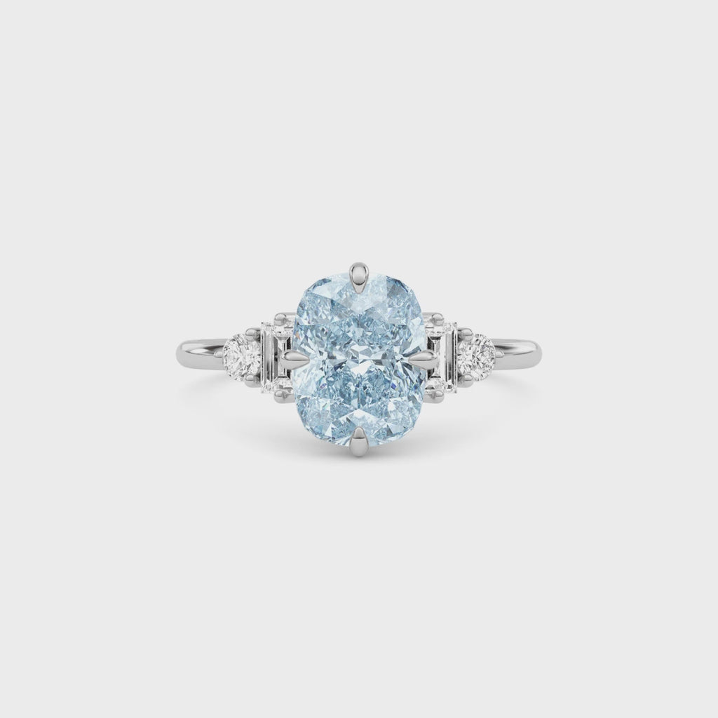 White gold Fancy Blue Cushion Cut Three Stone Diamond Engagement Ring with Tapered Baguette and Round Side Stones