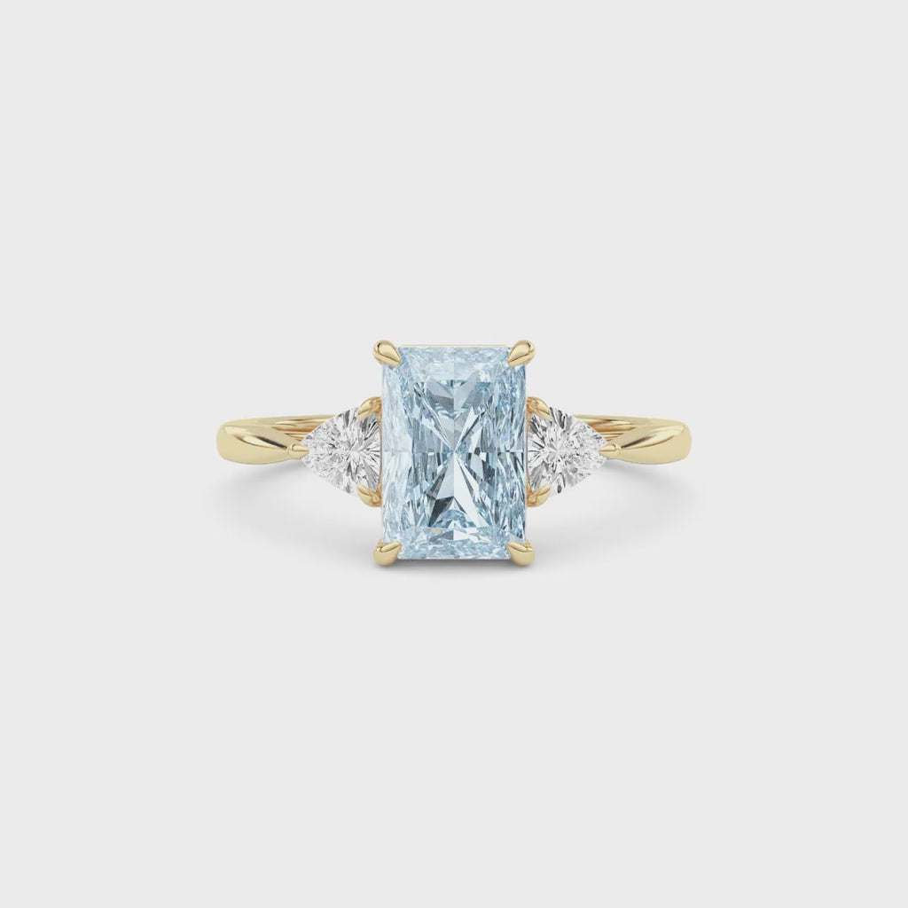 Yellow gold Three-Stone Fancy Blue Radiant Cut Diamond Ring with Trillion Side Stones
