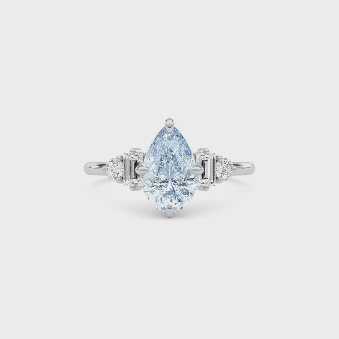 Platinum Fancy Blue Pear Cut Three Stone Diamond Engagement Ring with Tapered Baguette and Round Side Stones