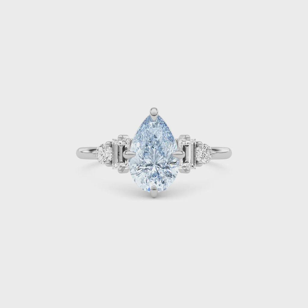 Platinum Fancy Blue Pear Cut Three Stone Diamond Engagement Ring with Tapered Baguette and Round Side Stones