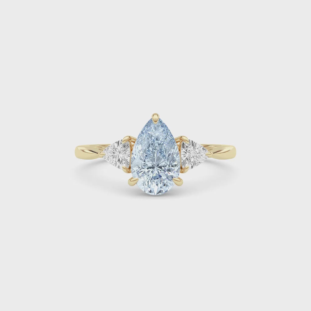 Yellow gold Three-Stone Fancy Blue Pear Cut Diamond Ring with Trillion Side Stones