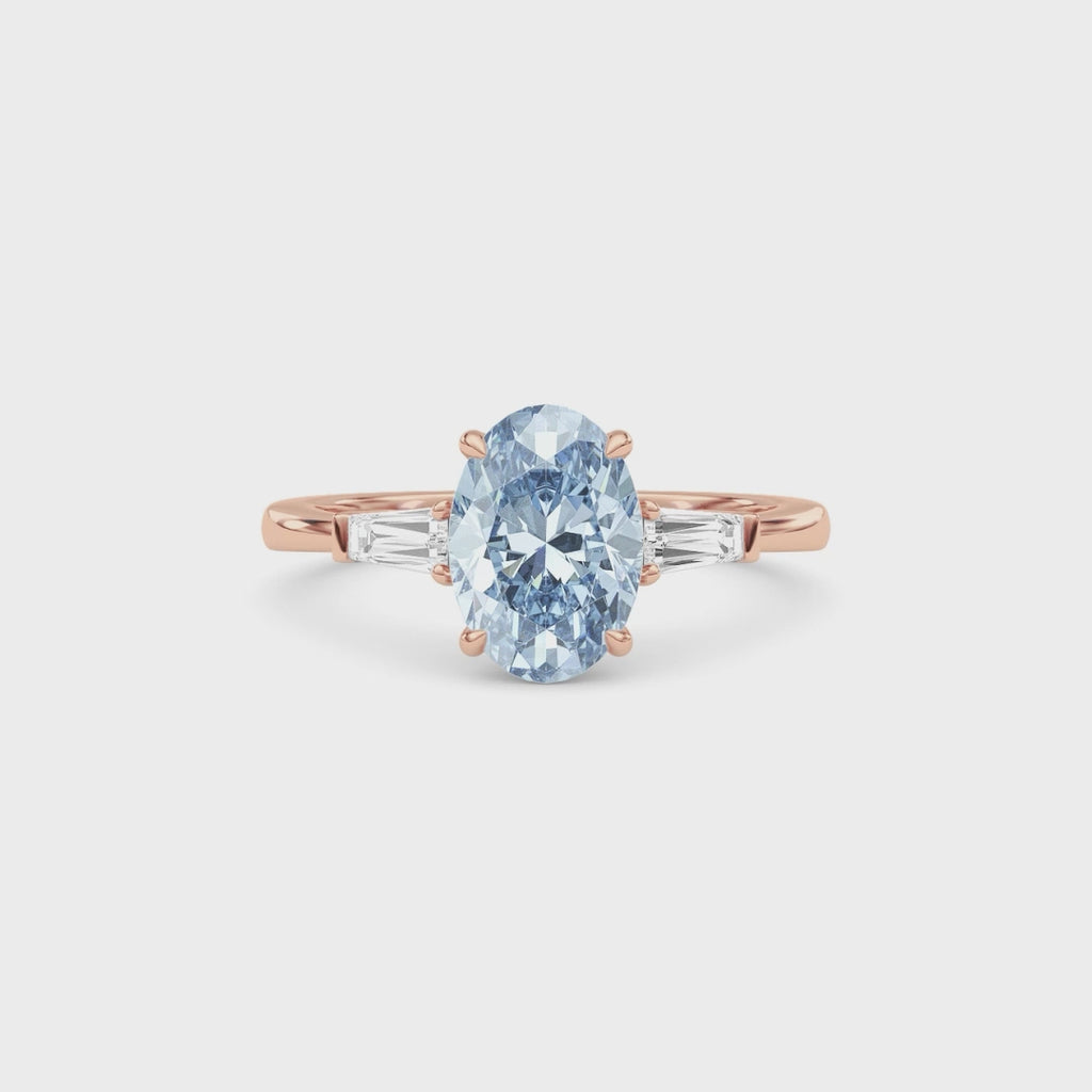 Rose gold Three-Stone Fancy Blue Oval Cut Diamond Ring with Tapered Baguette Side Stones