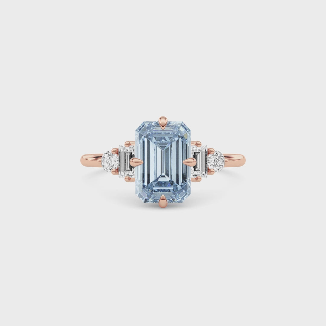 Rose gold Fancy Blue Emerald Cut Three Stone Diamond Engagement Ring with Tapered Baguette and Round Side Stones