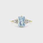 Yellow gold Fancy Blue Radiant Cut Three Stone Diamond Engagement Ring with Tapered Baguette and Round Side Stones