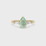 Yellow gold Three-Stone Fancy Green Pear Cut Diamond Ring with Tapered Baguette Side Stones