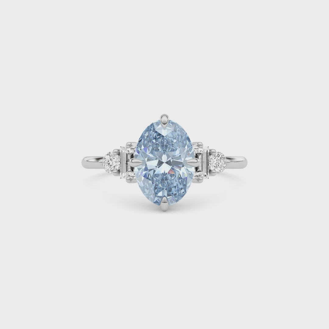 White gold Fancy Blue Oval Cut Three Stone Diamond Engagement Ring with Tapered Baguette and Round Side Stones