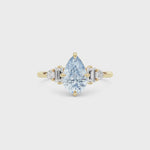Yellow gold Fancy Blue Pear Cut Three Stone Diamond Engagement Ring with Tapered Baguette and Round Side Stones