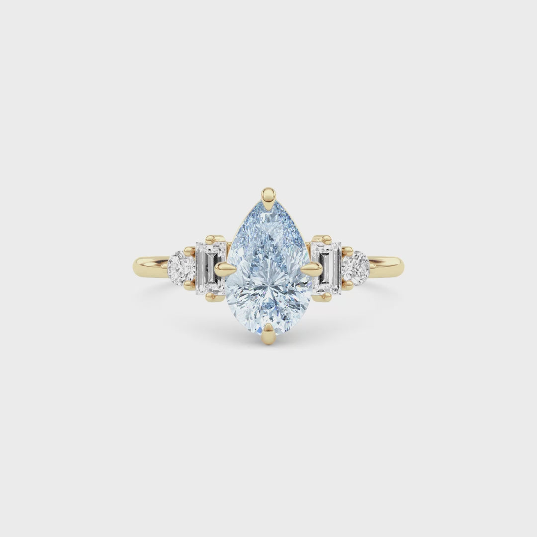 Yellow gold Fancy Blue Pear Cut Three Stone Diamond Engagement Ring with Tapered Baguette and Round Side Stones