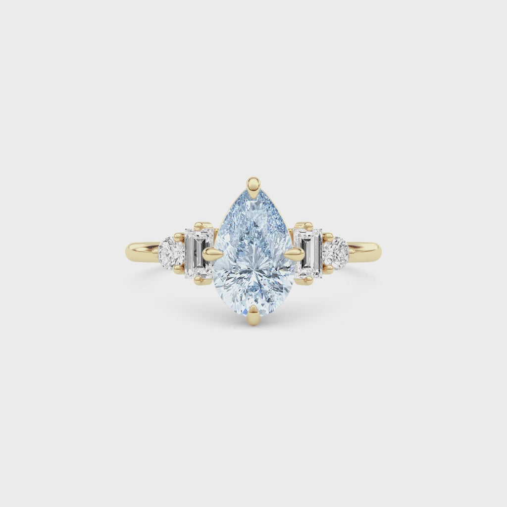 Yellow gold Fancy Blue Pear Cut Three Stone Diamond Engagement Ring with Tapered Baguette and Round Side Stones