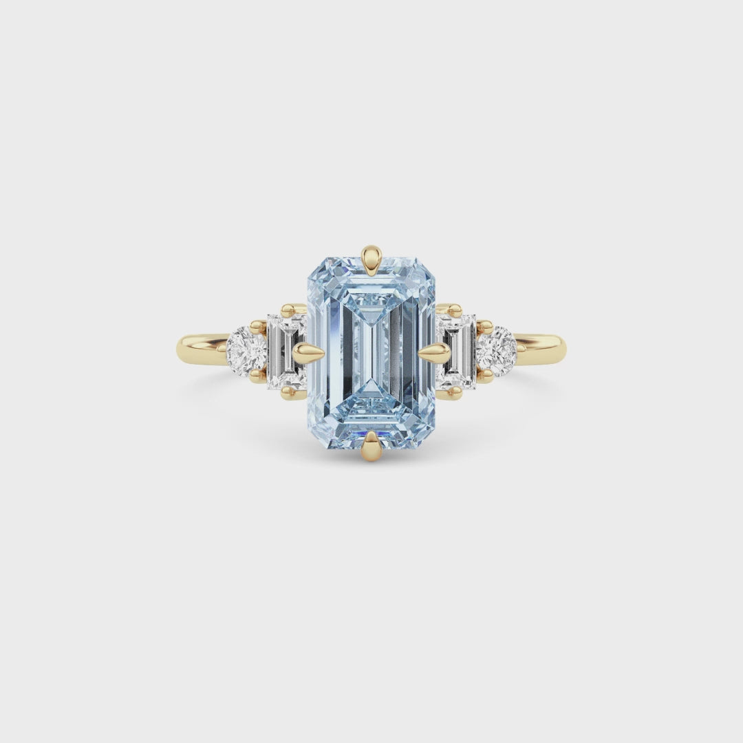 Yellow gold Three-Stone Fancy Blue Emerald Cut Diamond Ring with Heart Side Stones