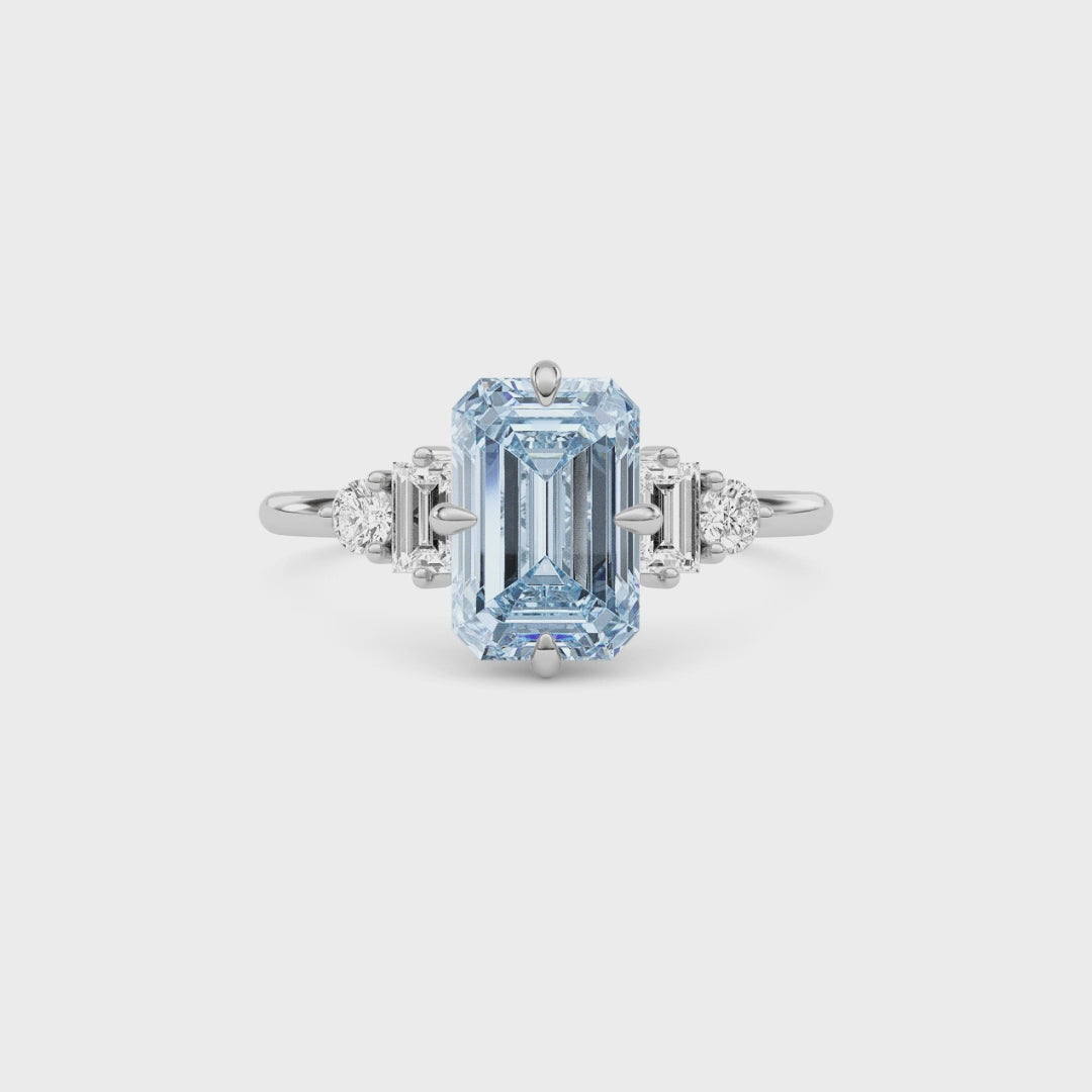 Silver Three-Stone Fancy Blue Emerald Cut Diamond Ring with Heart Side Stones