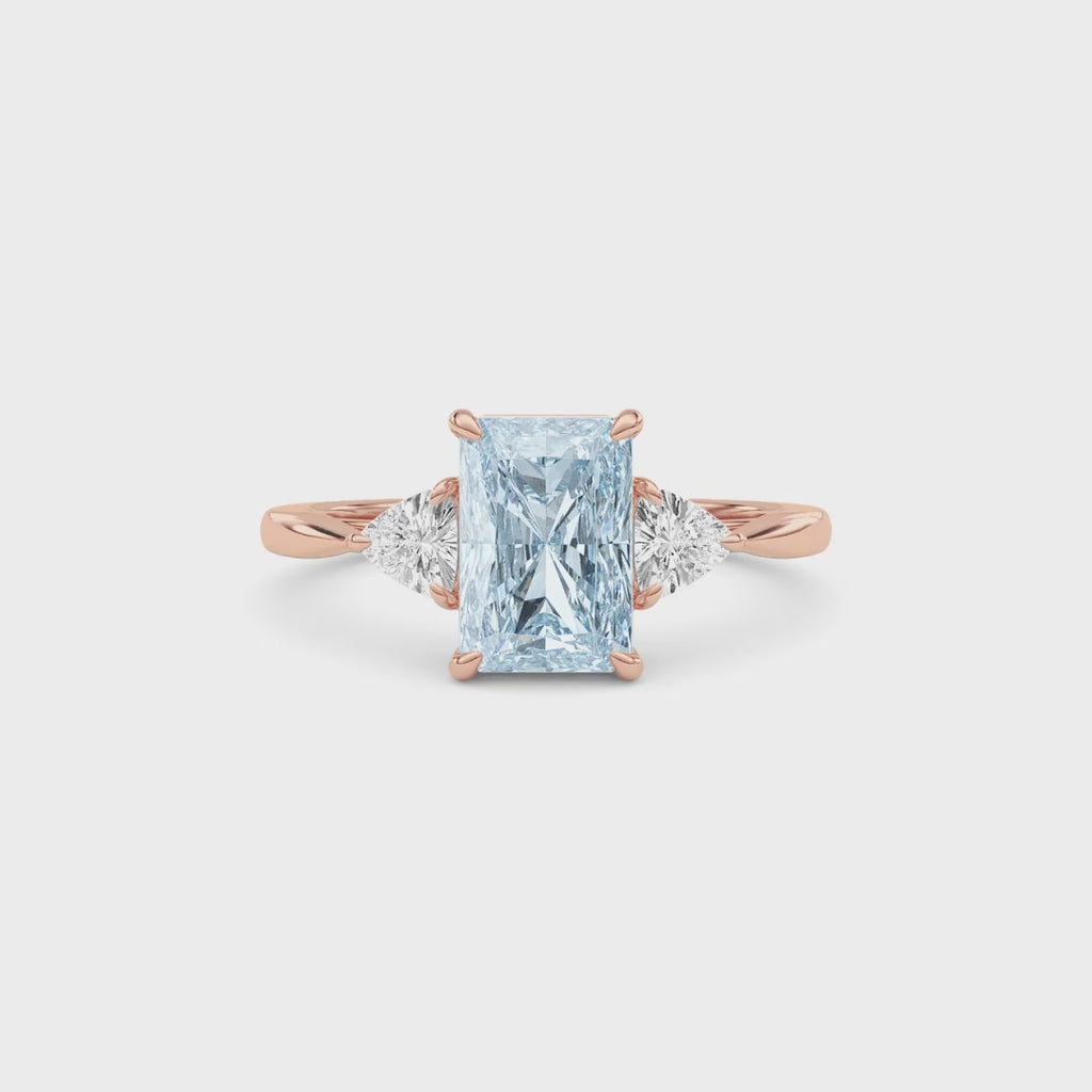 Rose gold Three-Stone Fancy Blue Radiant Cut Diamond Ring with Trillion Side Stones