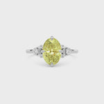 Yellow gold Fancy Yellow Oval Cut Three Stone Diamond Engagement Ring with Tapered Baguette and Round Side Stones