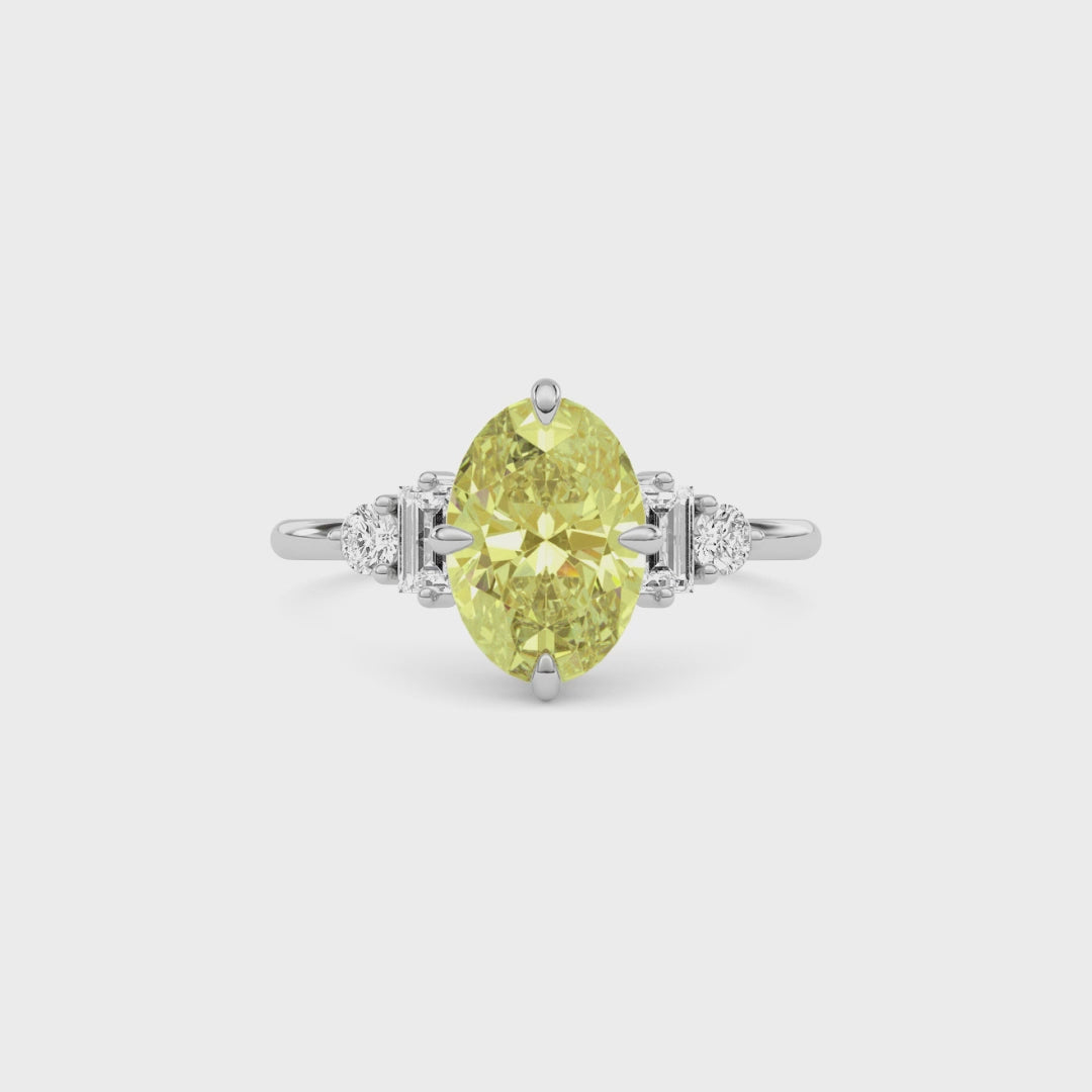 Yellow gold Fancy Yellow Oval Cut Three Stone Diamond Engagement Ring with Tapered Baguette and Round Side Stones